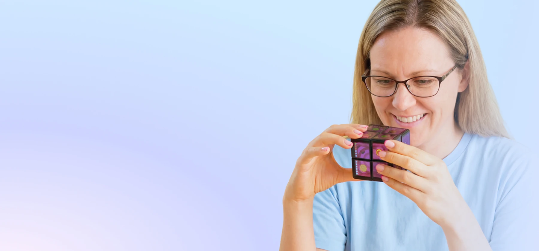 A woman holds a WOWCube in her hands
